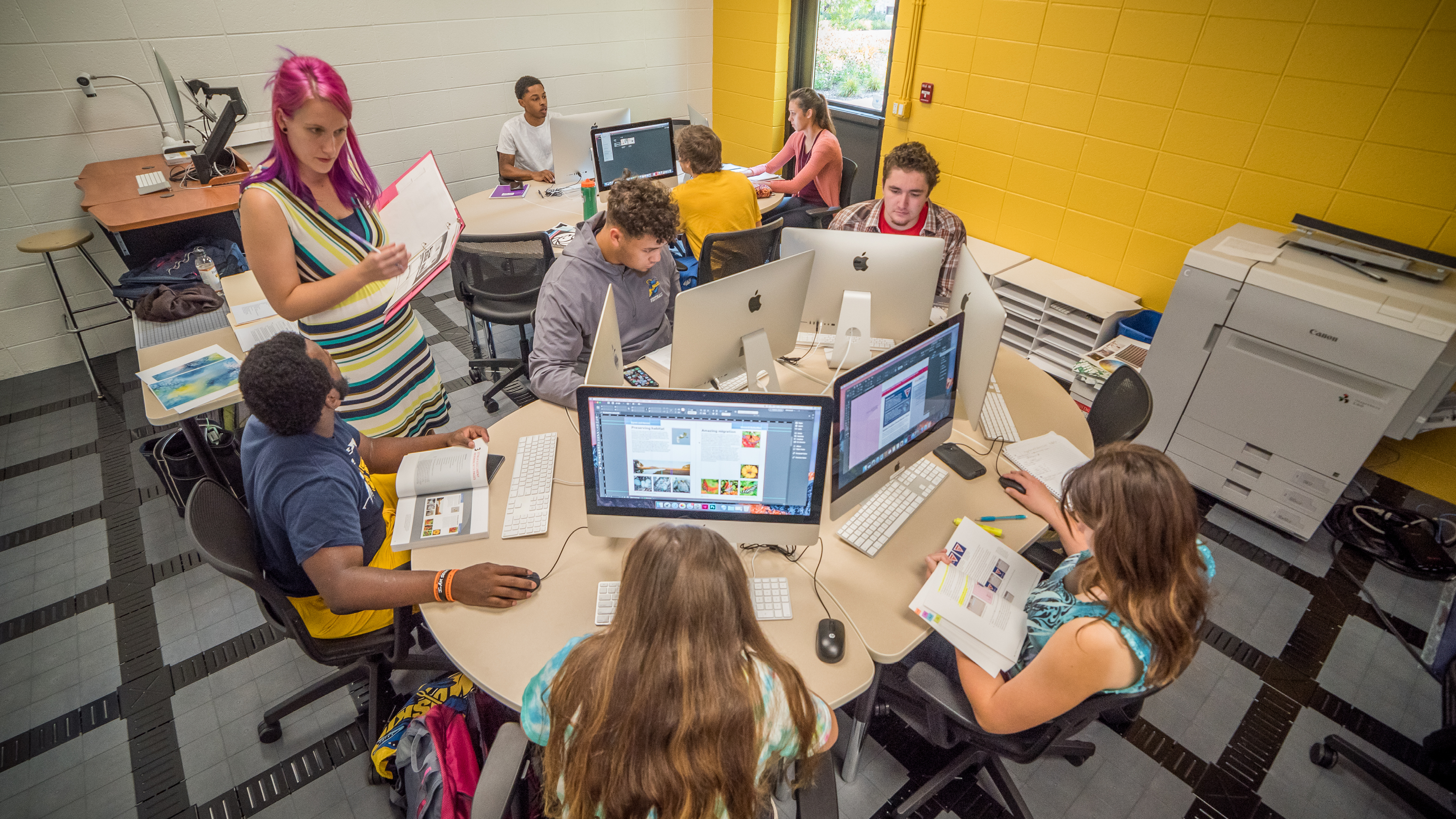 Monique Brickham working with students in Lakeland University’s graphic design classroom